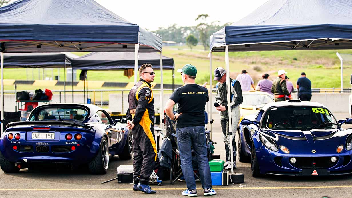 Two Drivers Talking At A Lotus Club In Australia Doing Track Days Like CSCA At Wakefield And Eastern Creek Racing Circuit Next To A Exige Sports Car